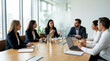 © Xenia - Diverse corporate team having a board meeting in a modern office. Female executive leading a strategic discussion at a conference table. Business leadership and teamwork concept