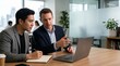 © Eve - Business mentor training employee and pointing at laptop screen, executive leader coaching intern during meeting in office, professional consulting and corporate mentorship program