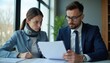 © Viktor - Woman with neck brace and lawyer review papers in office. Client seeks legal advice for injury compensation or insurance claim. Pro consultation meeting.