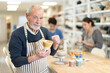 © JackF - Elderly potter demonstrates a clay cup he made with his own hands