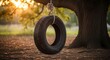 © pan - Tire swing hanging from large tree with sunlight backdrop outdoors scene