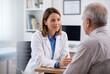 © Meow Creations - Female doctor talking with a senior male patient during a consultation in a clinic office
