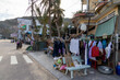 © Zenstratus - A woman rides a motorbike past a street with clothes drying on a sunny day in Nhon Hai, Quy Nhon, Binh Dinh, Vietnam.