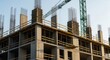 © Ariestia - Construction site shows a building under development with concrete columns and scaffolding.