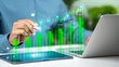 © Wachirapong - Businessman analysis green growth graph and sustainable investment strategy for year 2026 to 2030 with ESG goals and digital technology on virtual screen.