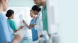 © Mr. Bolota - Diverse medical team collaborating and diagramming on a whiteboard