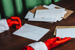 © VISTA by Westend61 - Santa Claus writing humorous Christmas letter about capitalism at desk