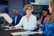 © Rido - Mature businesswoman smiling during brainstorming