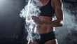 © SolaruS - Dramatic shot of a muscular female athlete clapping chalk before training. This evocative image represents strength and grit, ideal for gym marketing and fitness motivation content.
