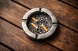 © AkuAku - Aerial shot showing a metal ashtray on a textured wooden table