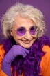 © alvaro - Senior woman smiling wearing vibrant purple accessories