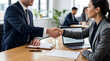 © Zulharyono - Professional handshake between a man and woman in a business meeting, symbolizing agreement and partnership
