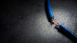 © Olesya - Cut blue internet cable on dark floor. Network disconnection and communication breakdown. Social media blocking and cyber security concept. Digital connection failure and internet censorship.