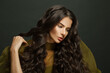 © millaf (Nemchinova) - Brunette woman hair. Beautiful model with long curly hairstyle posing