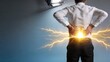 © Lin - Business man suffering from severe lower back pain due to working in office holding his waist with hands as lightning flashes symbolizing sharp ache and injury