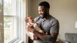 © vefimov - A heartwarming scene of a father cherishing his first moments with his newborn baby at home by the window.