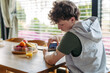 © Halfpoint - Teen boy with diabetes scanning glucose level using CGM sensor and smartphone.