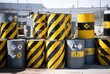 © Kitta Studio - Hazardous waste barrels stacked outdoors with warning symbols and hazard stripes