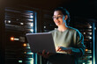 © Konstantin Yuganov - Confident Female IT Specialist Working Late in Server Room