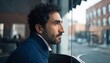 © n0feel_studio - Contemplative man with beard gazing thoughtfully through blurred window urban portrait photography cozy indoor setting side profile view reflection and introspection
