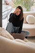 © gzorgz - Confident woman using her laptop at home