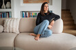 © gzorgz - Portrait of a brunette haired woman relaxing in her modern home