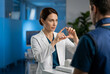 © Viktoria - Strategic medical expert explaining a complex procedure in a high-tech facility. The shot captures clinical authority and the sophisticated, high-stakes atmosphere of modern healthcare.