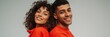 © Andrii Zastrozhnov - Smiling couple standing back to back against neutral background