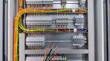 © Sekai - Open electrical switchboard with a multitude of colorful wiring including vibrant tones industrial photography detail