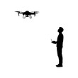© Kuldi - silhouette of a person playing drone on a white background