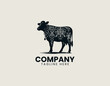 © Dawi Firdaus - Black decorative cow silhouette is displayed in elegant ornamental vector logo style