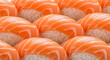 © Adis N. Tyas - Heap of salmon nigiri sushis fulfilling the entire screen. Can be utilized for full screen food display especially for Japanese cuisine related