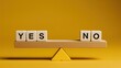 © Арман Амбарцумян - Wooden blocks with Yes and No words balancing on a seesaw scale. Business choice, decision making and dilemma concept on yellow background