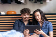 © Westend61 - Woman sharing tablet PC with boyfriend at home