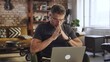 © nyul - Mature man deep in thought while working on laptop at home. Remote working businessman looking for solution and new ideas. Male entrepreneur managing business online, thinking.