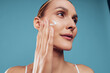 © SHOTPRIME STUDIO - Woman applies moisturizer cream to her face during skincare routine, beauty and spa mood, health and hygiene care for smooth skin, natural glow, soft copyspace