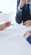 © volha_r - Business colleagues reviewing contract documents during an office meeting, discussing terms, and preparing for agreement signing, focusing on legal consultation and partnership discussion