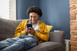 © ReeldealHD images - Teen boy Relaxing on Sofa Using Smartphone at Home