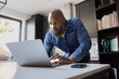 © ReeldealHD images - Focused Man Working on Laptop in his kitchen