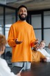© Andrii Zastrozhnov - Young man presenting to team in modern conference room