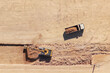 © Nasos Zovoilis - Heavy machinery including an excavator digging a trench, loading a dump truck with earth and rocks during extensive earthmoving operations at a large commercial construction site