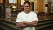 © Krakenimages.com - Man adjusting glasses and smiling in ornate church building with altar and steps visible; quiet joy reflection.