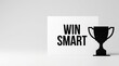 © Chopang.studio - Win smart motivational message on white card with black trophy silhouette symbolizing success and achievement in competition or goal