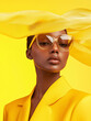 © Femmes.Digital - Stylish portrait of woman in monochrome yellow suit with oversized glasses and flowing fabric hat. Bold luxury fashion image for branding campaign and editorial design.