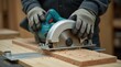 © Alex Pios - Carpenter wears gloves using circular saw to cut wood plank. Sawdust flies as tool cuts timber. Safety guard is in place during woodworking task.