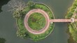 © Ambea Creative World - Aerial view of a circular pathway and garden on a small island in a body of water