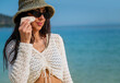 © boryanam - Beautiful Woman applying spf sunscreen on a sea background