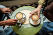 © ADDICTIVE STOCK - Multiethnic friends sharing latte art coffee at cafe table
