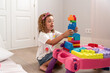 © ADDICTIVE STOCK - Child building colorful block tower at play table indoors