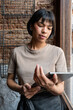 © ADDICTIVE STOCK - Bakery staff checking order on tablet near rustic window